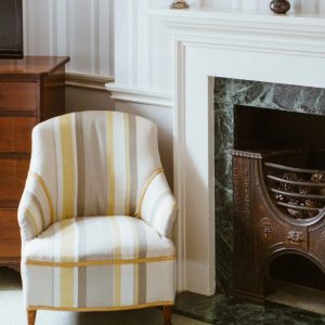 white-yellow-and-gray-striped-arm-chair
